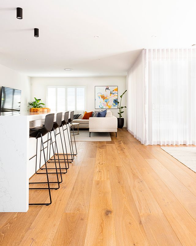 A living room with hardwood floors and a couch.