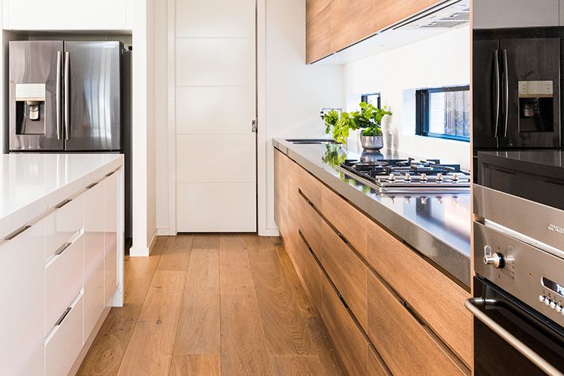 A kitchen with wooden cabinets and stainless steel appliances