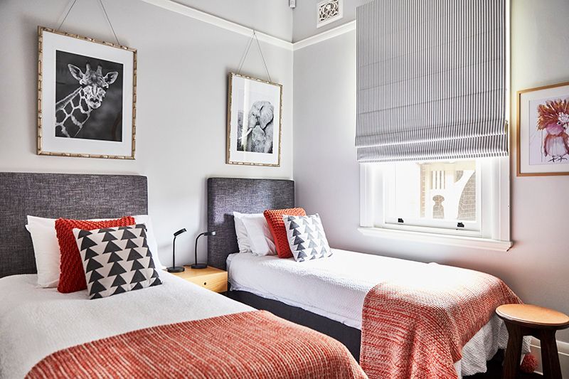 A bedroom with two twin beds and a window