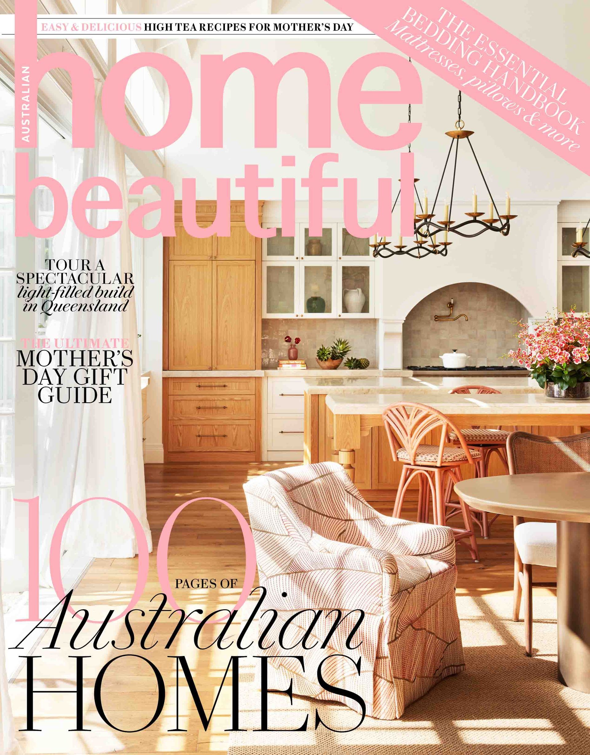 The cover of a home beautiful magazine with a couch and stools on it.