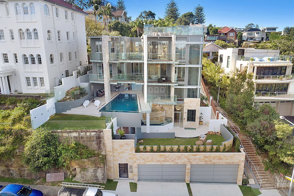 An aerial view of a large apartment building with a swimming pool