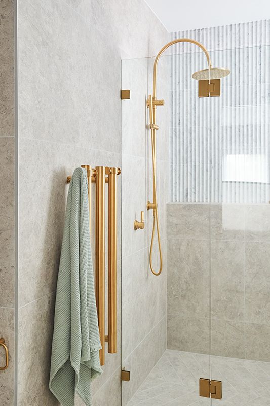 A bathroom with a shower and a towel hanging on the wall.