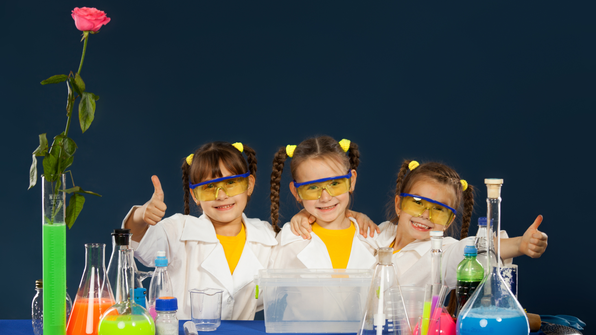 kids in science lab coats with beakers