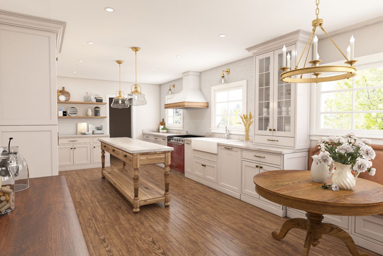 Bright white kitchen with island, wood floors, brass pendants, and a round table by sunlit windows