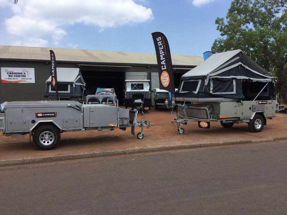 Two Trailers Are Parked on the Side of the Road in Front of a Building — Darwin Caravan & RV Centre In Berrimah, NT
