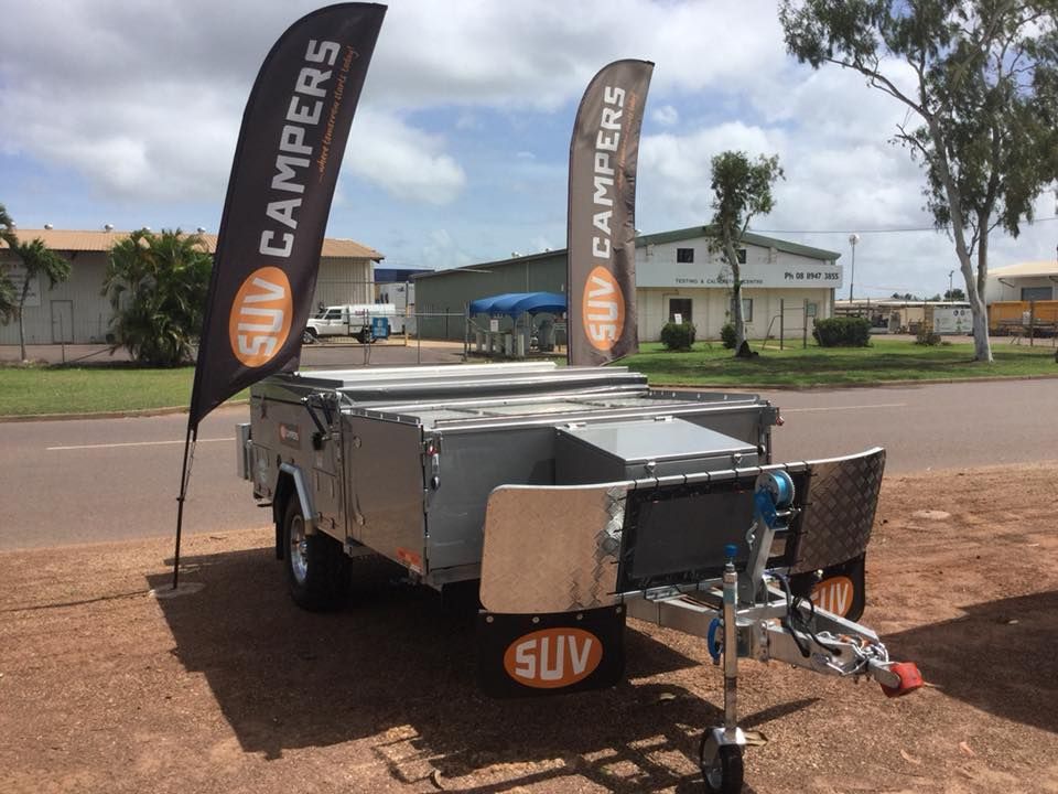 A Trailer With Two Flags on It That Say Suv Campers — Darwin Caravan & RV Centre In Lee Point, NT