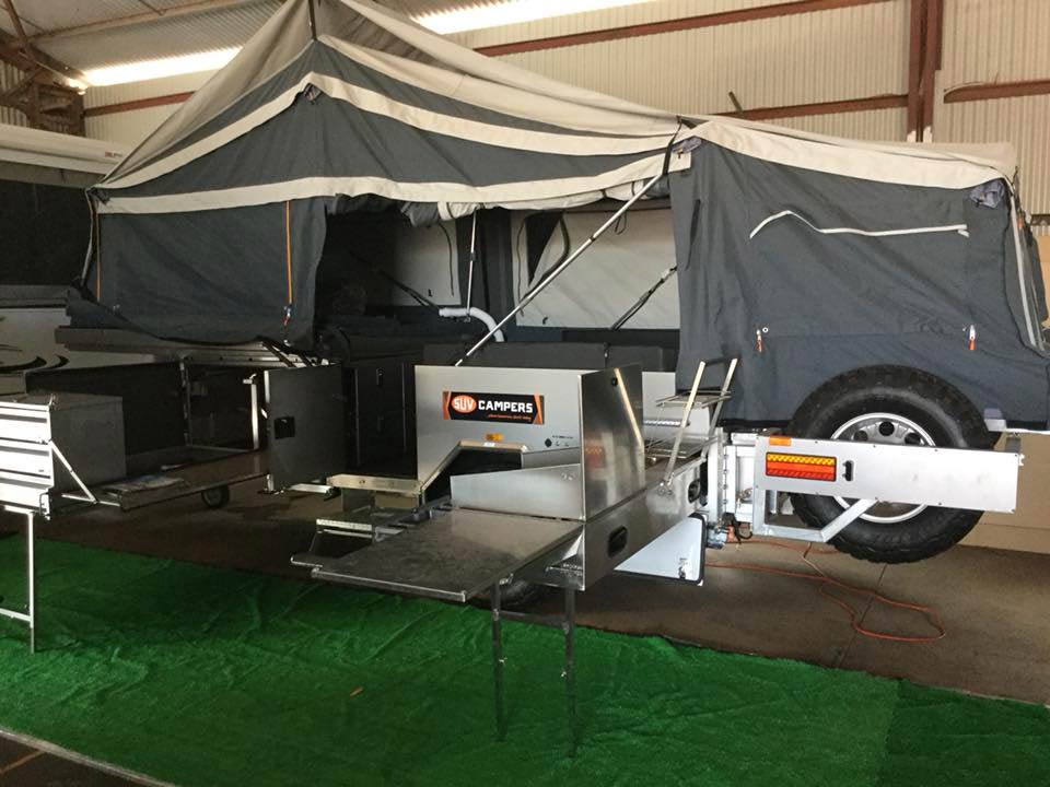 A Trailer With a Tent on Top of It is Parked in a Garage — Darwin Caravan & RV Centre In Berrimah, NT
