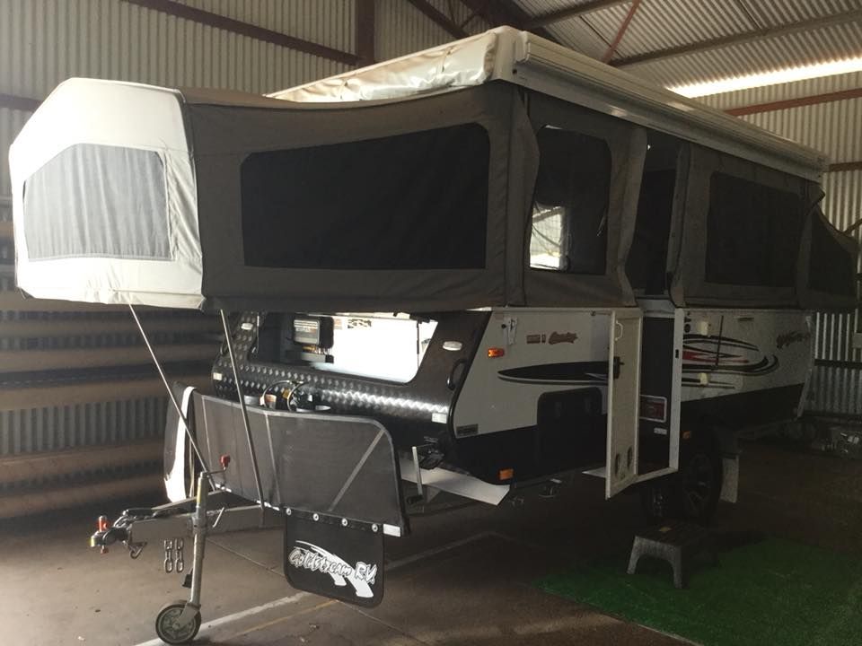 A Trailer With a Tent on Top of It is Parked in a Garage — Darwin Caravan & RV Centre In Berrimah, NT