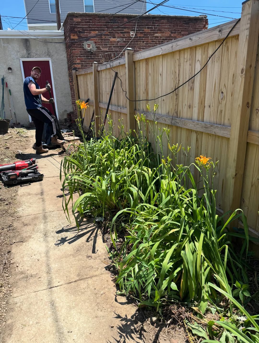 Levin Management landscapers preparing a client's backyard garden for planting.