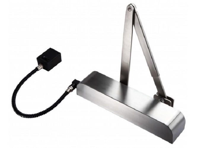 Silver automatic door closer with black hose connected to a small black box