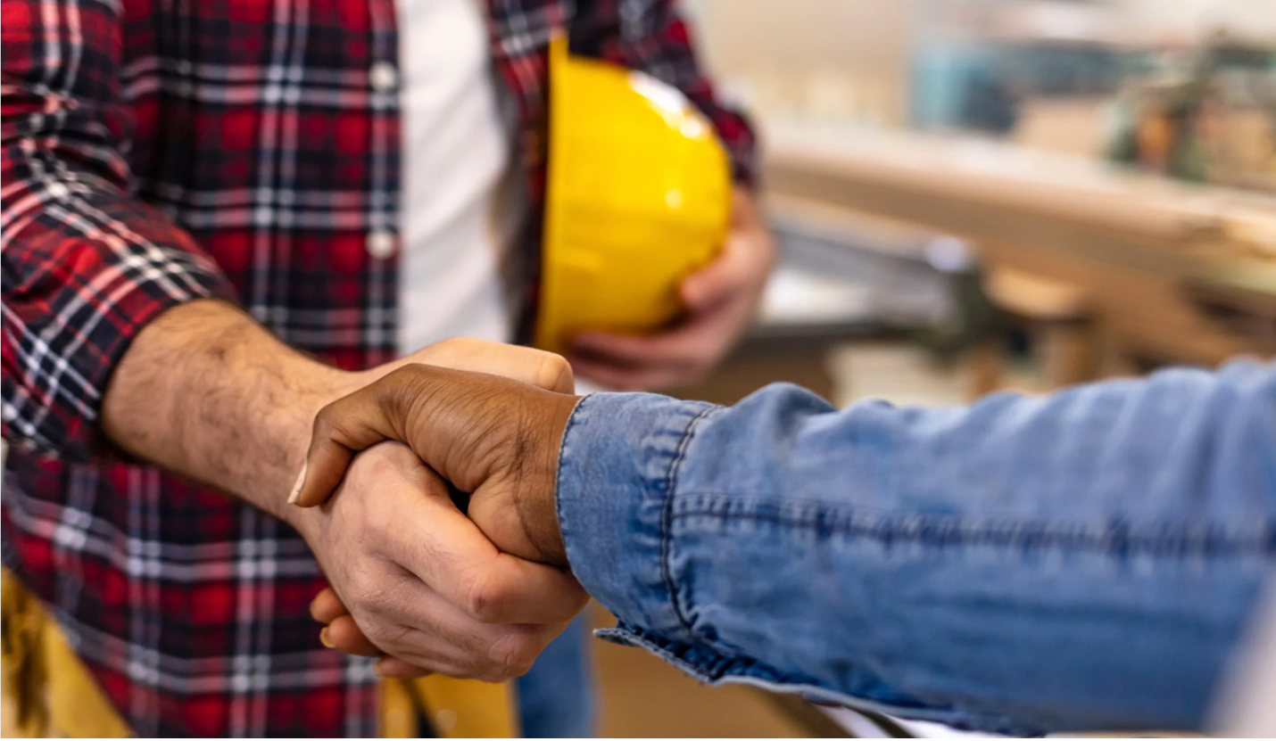 Contractor shaking a client's hand.