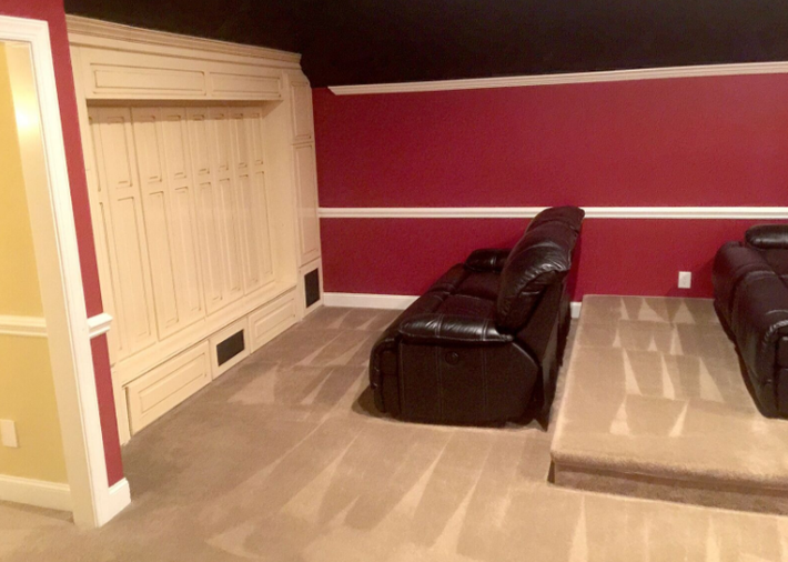 A living room with two couches and a red wall