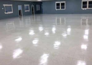 A large room with a white floor and blue walls