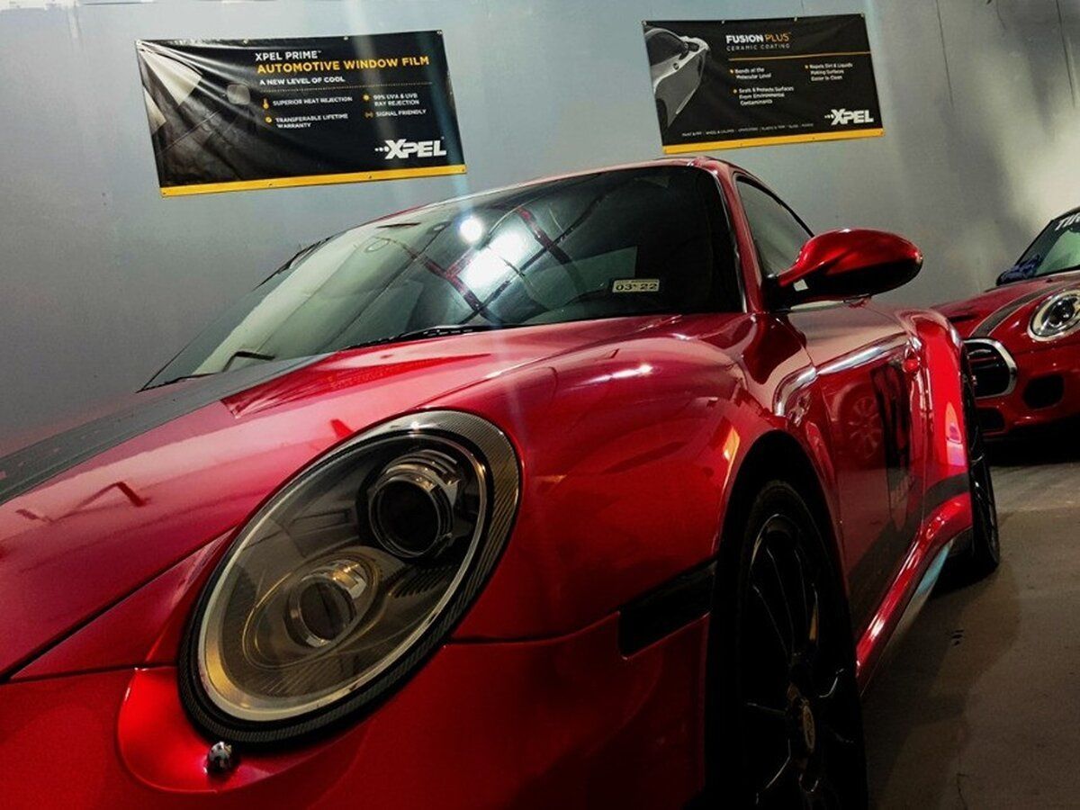 a red porsche 911 is parked in a garage
