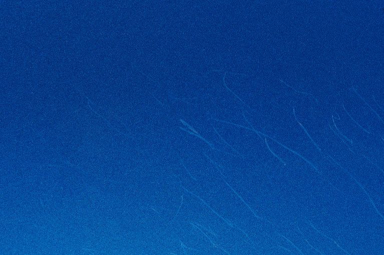 A close up of a blue background with a grainy texture.