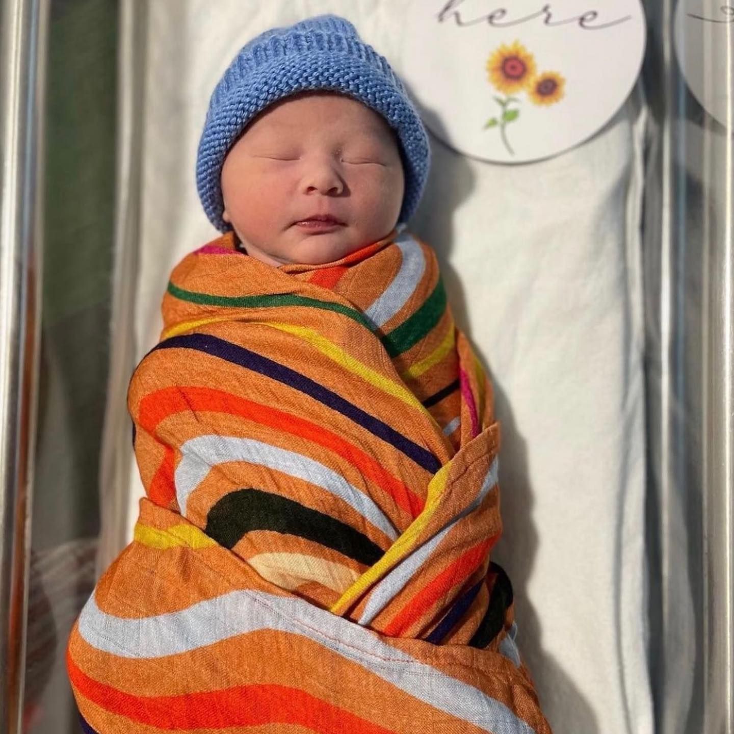 Newborn Baby Wrapped in Colourful Blanket — Decadence Gifts & Homewares in Central Highlands, QLD