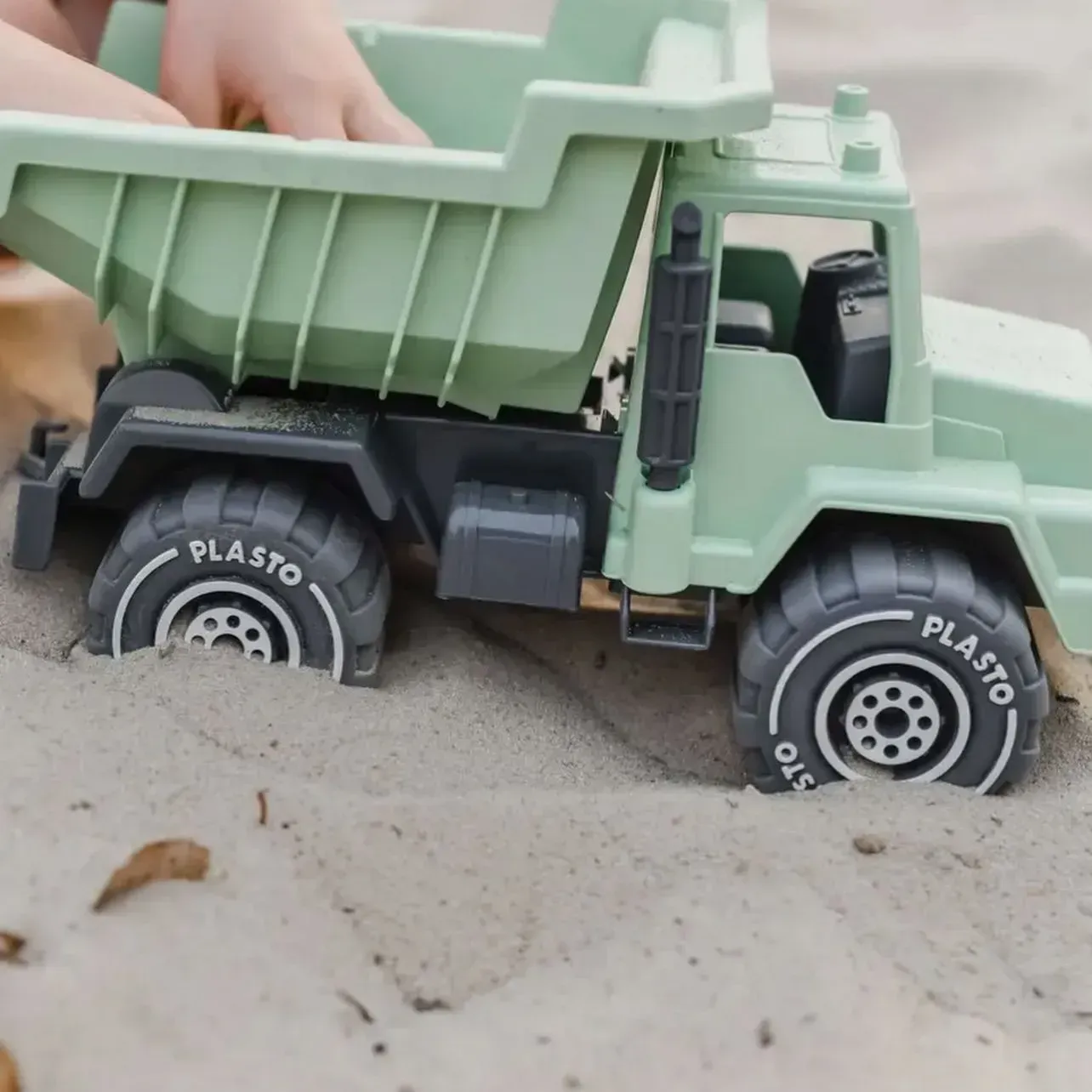 Green Toy Dump Truck in Sand, Tires Labeled Plasto — Decadence Gifts & Homewares in Springsure, QLD