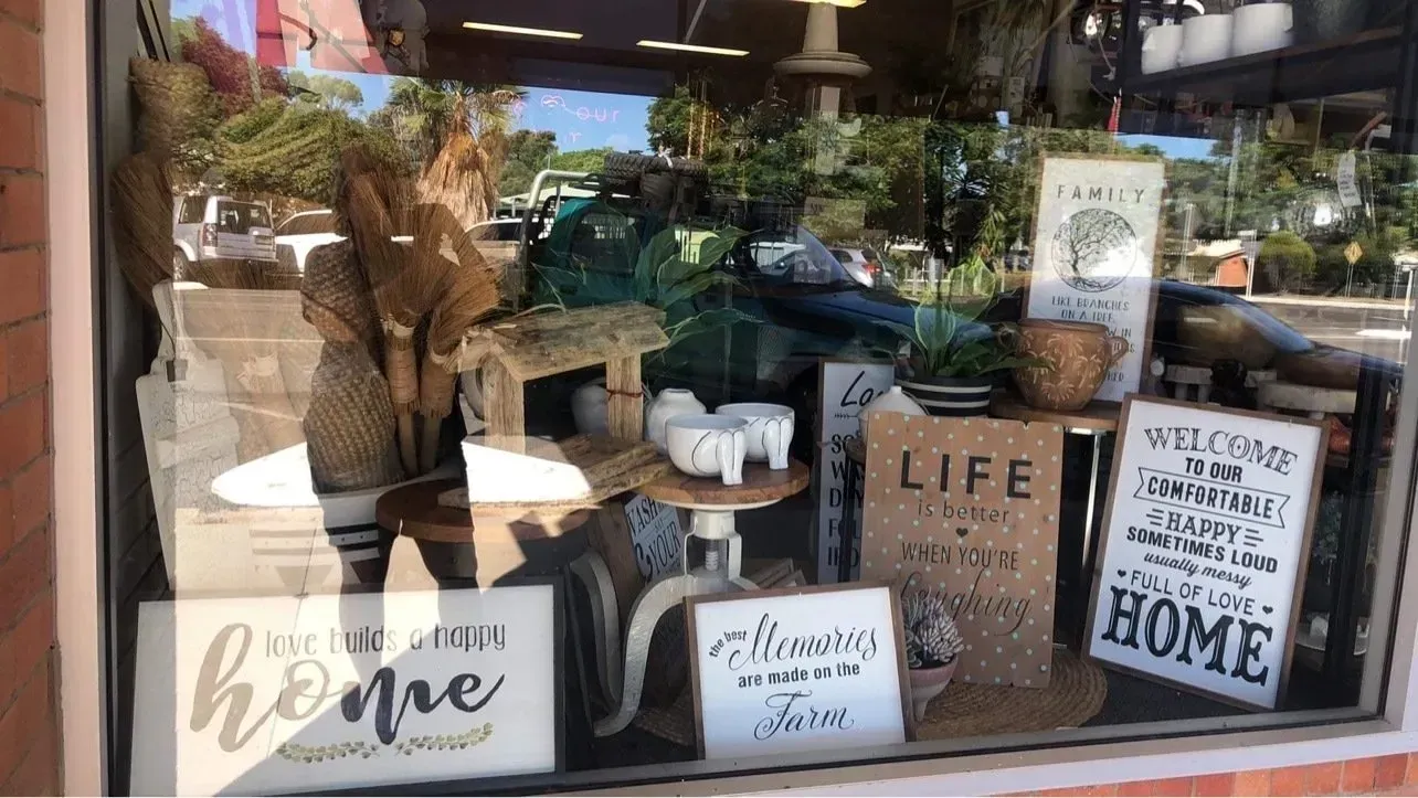 Shop Window Display With Farmhouse Decor and Signs — Decadence Gifts & Homewares in Springsure, QLD