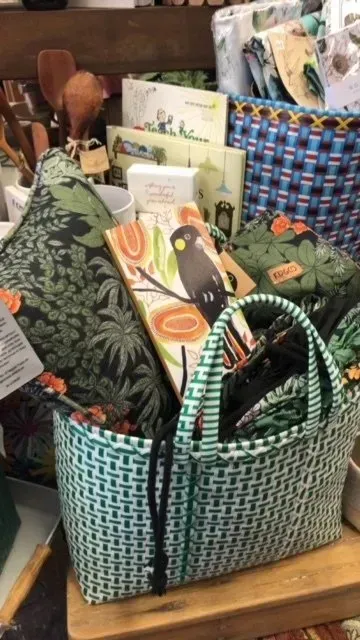 Green and White Woven Basket Filled With Items — Decadence Gifts & Homewares in Springsure, QLD