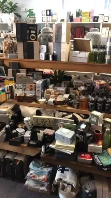 Shelves Overflowing With Boxes and Merchandise Inside a Cluttered Store — Decadence Gifts & Homewares in Springsure, QLD
