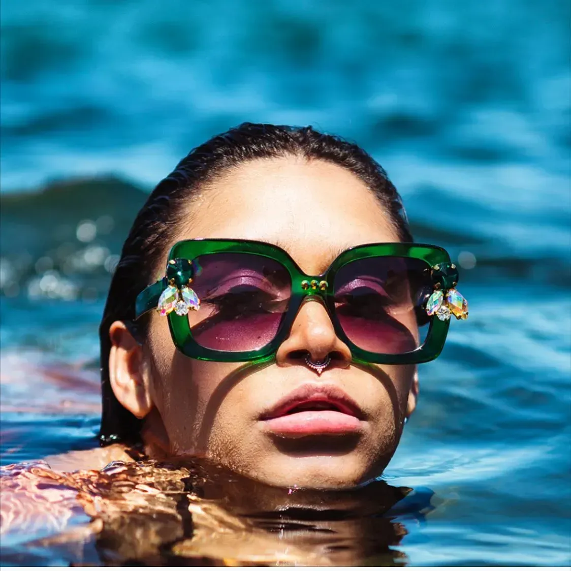 Woman in Green Sunglasses With Nose Ring, Emerges From Blue Water — Decadence Gifts & Homewares in Springsure, QLD