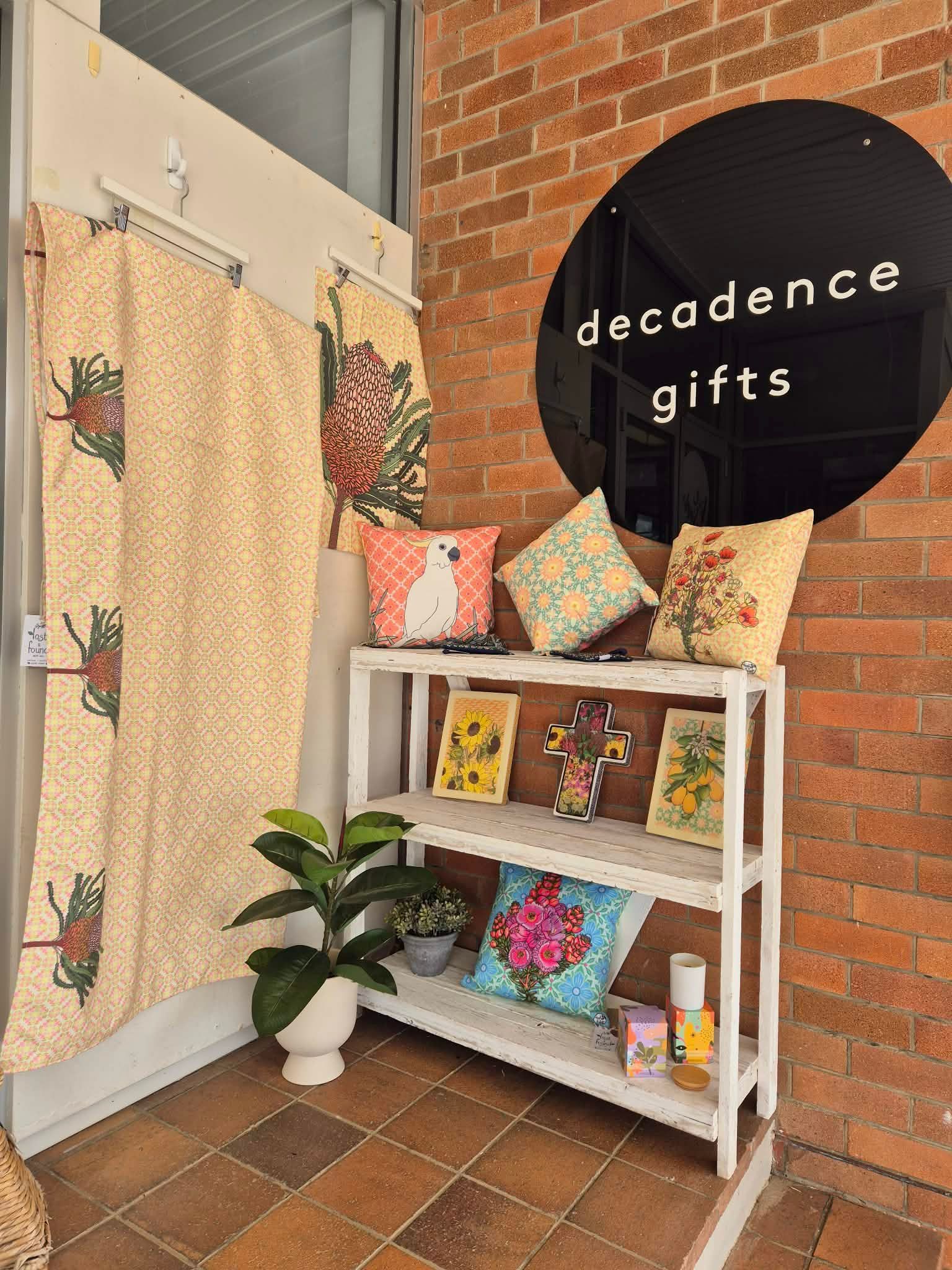 Shopfront With a Black Circular Sign Reading Decadence Gifts — Decadence Gifts & Homewares in Springsure, QLD