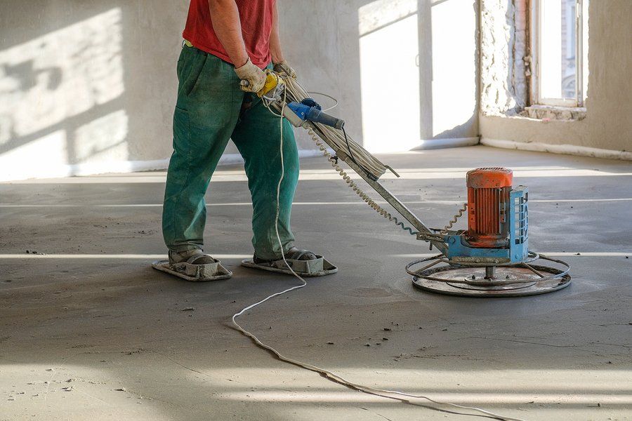 worker using a rotating trowel