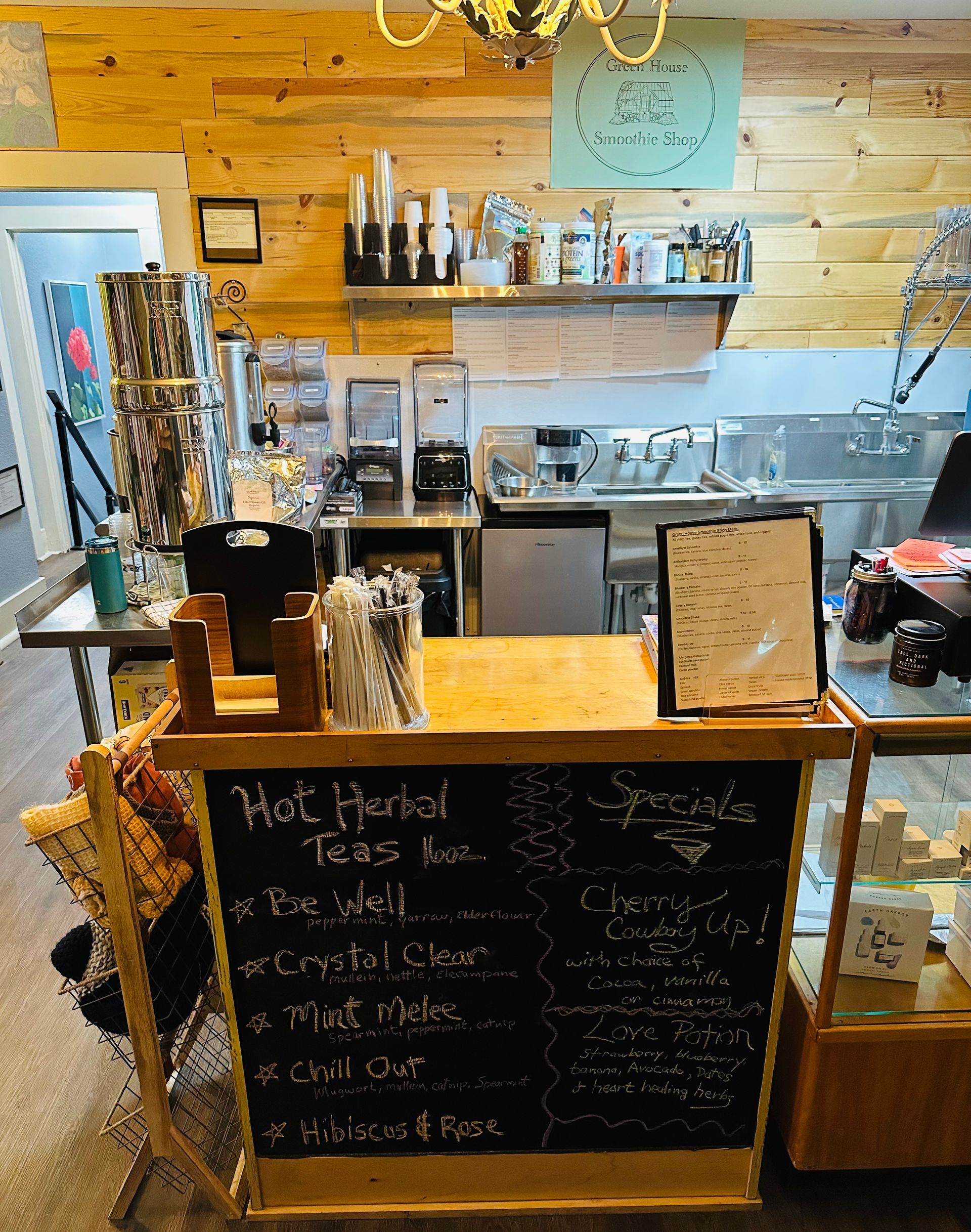 A restaurant with a chalkboard that says hot herbal tea on it