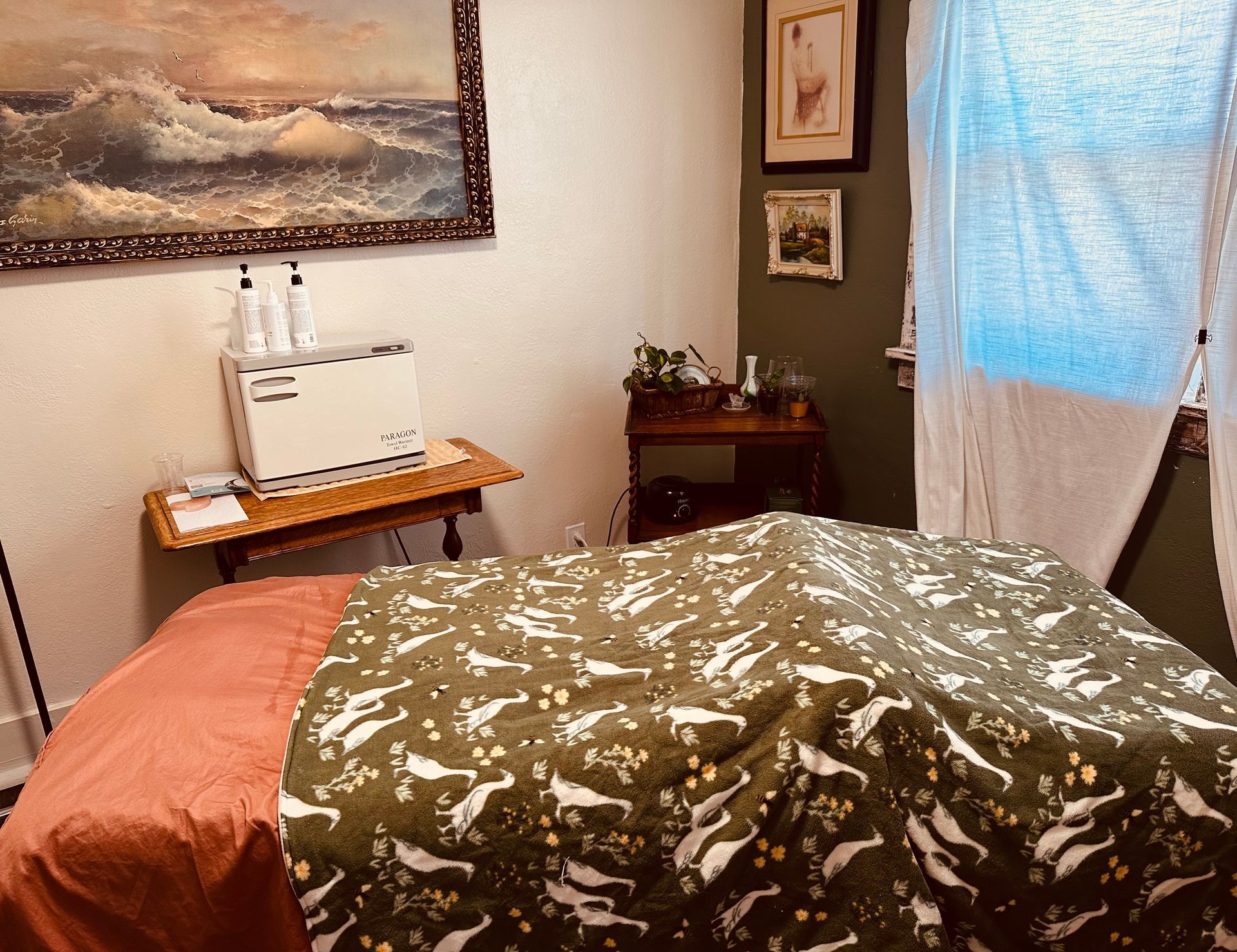 A room with a bed and a painting on the wall
