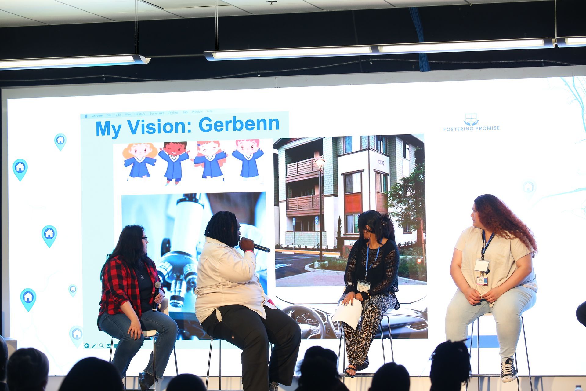 Panel discussion on stage with four seated speakers under a “My Vision: Gerbenn” presentation backdrop