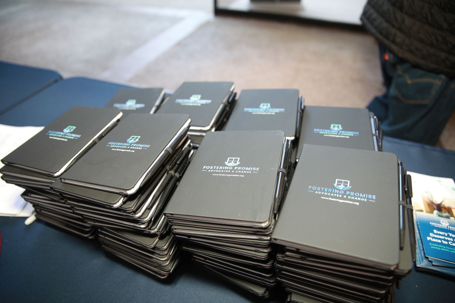Stacks of black award plaques arranged on a table at an event.