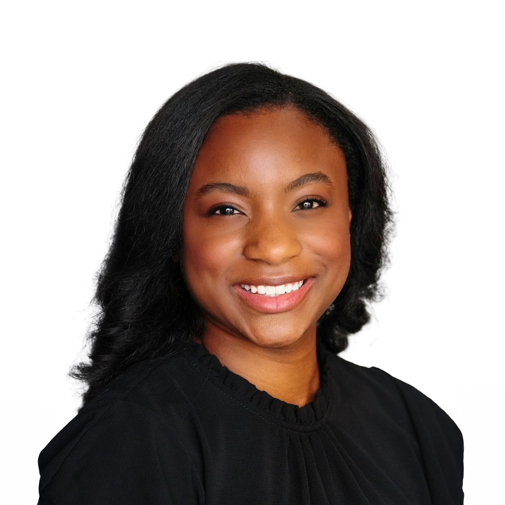 Smiling woman with shoulder-length black hair wearing a black top against a white background