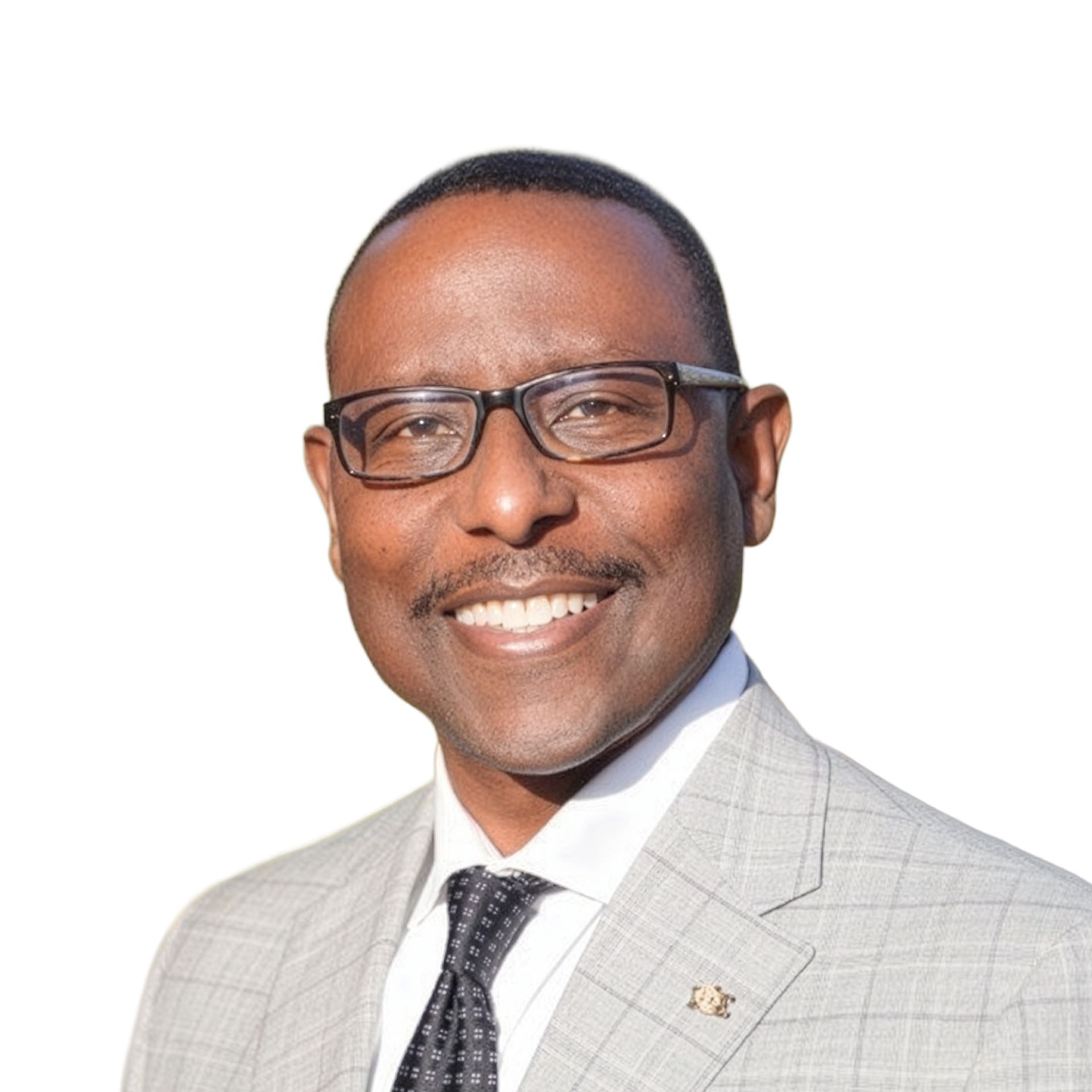 Smiling man in glasses and a light gray suit against a white background