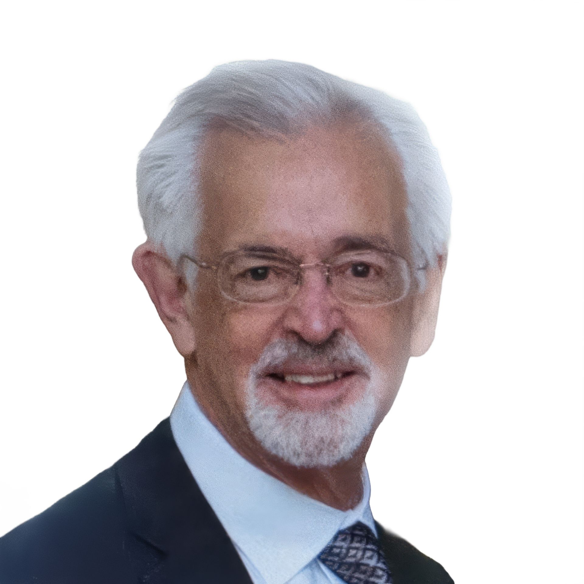 Portrait of an older man in a dark suit and tie, smiling against a white background