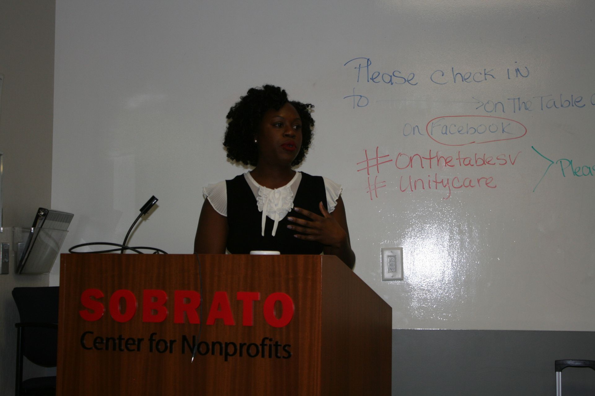 Speaker at a podium labeled “SOBRATO Center for Nonprofits,” presenting in front of a whiteboard