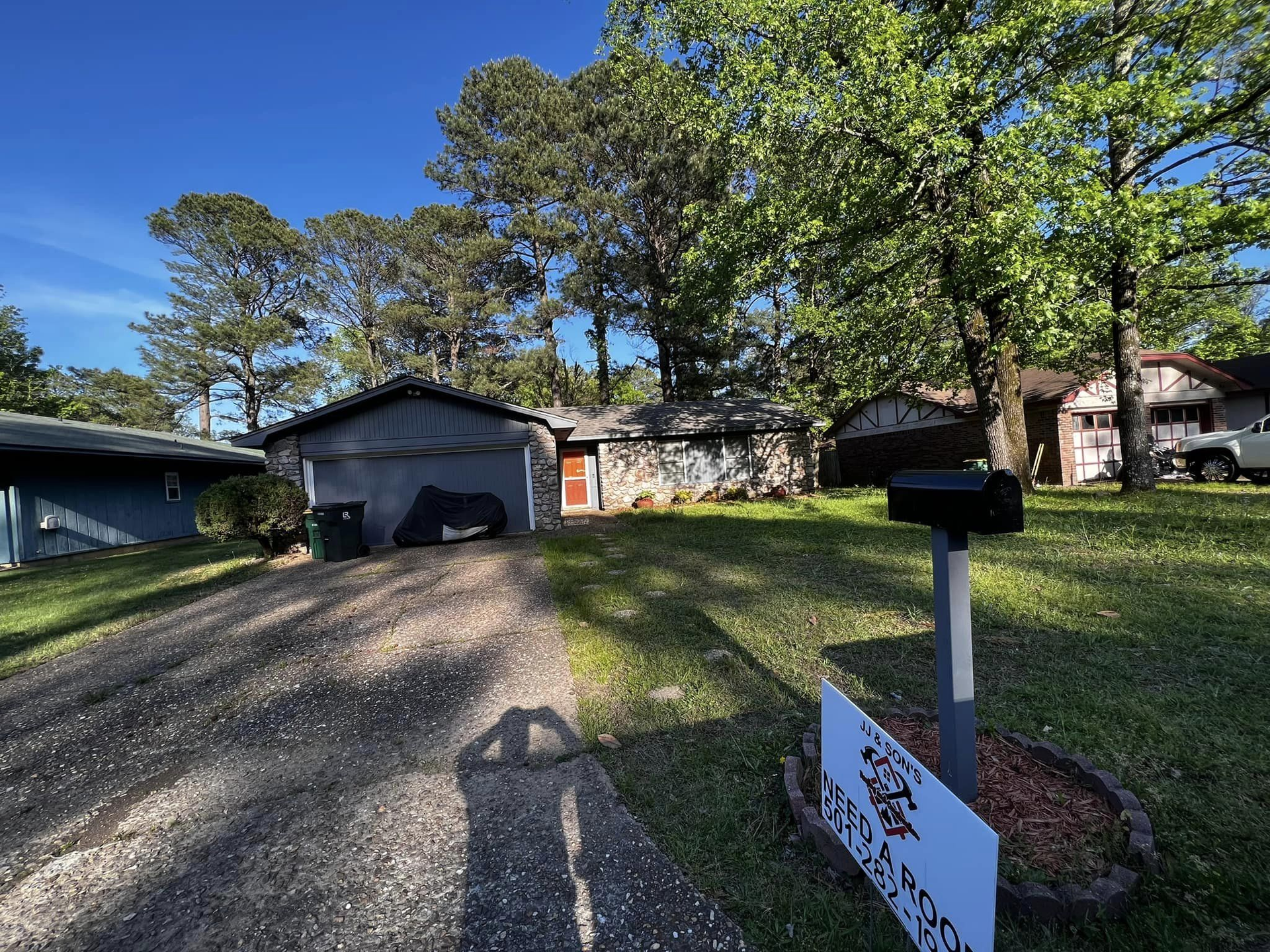 A house for sale with a mailbox in front of it