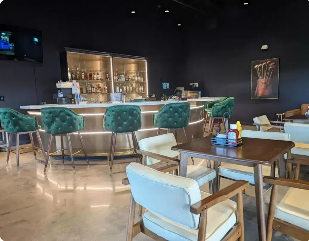 A restaurant with tables and chairs and a bar