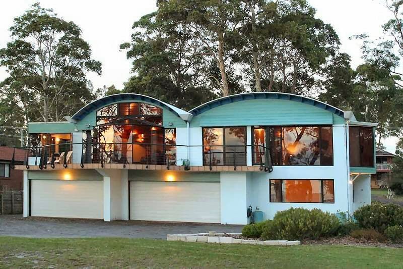 A Large House With A Lot Of Windows And Trees In The Background — South Coast Glass In South Nowra, NSW