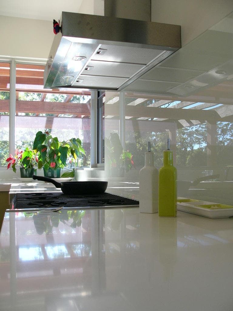 A Kitchen With A Stove Top Oven And A Stainless Steel Hood — South Coast Glass In South Nowra, NSW