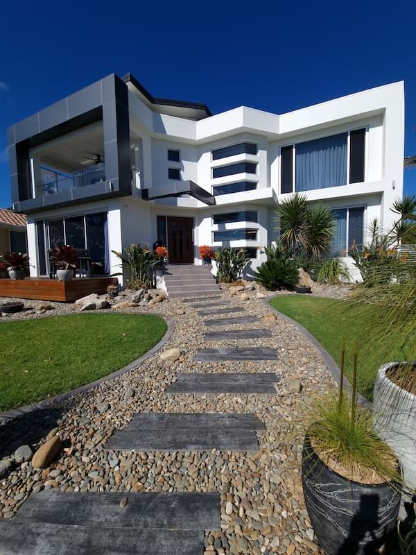 A Large White House With A Walkway Leading To It — South Coast Glass In South Nowra, NSW