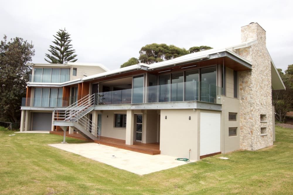 A Large House With A Lot Of Windows And Stairs — South Coast Glass In South Nowra, NSW
