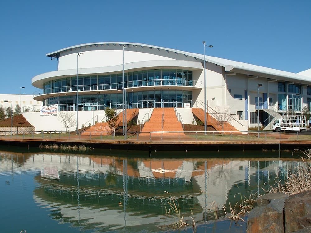 A Large Building Is Sitting Next To A Body Of Water — South Coast Glass In South Nowra, NSW