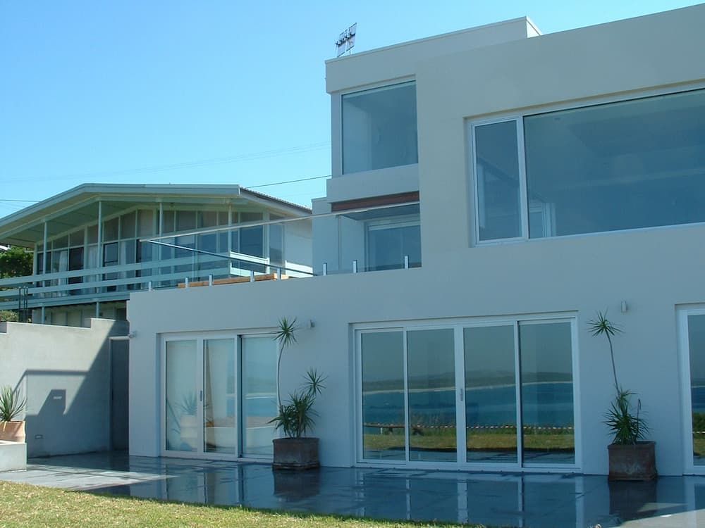 A Large White House With A Lot Of Windows — South Coast Glass In South Nowra, NSW
