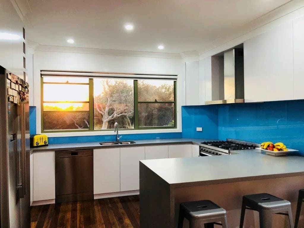 A Kitchen With White Cabinets And Blue Counter Tops — South Coast Glass In South Nowra, NSW