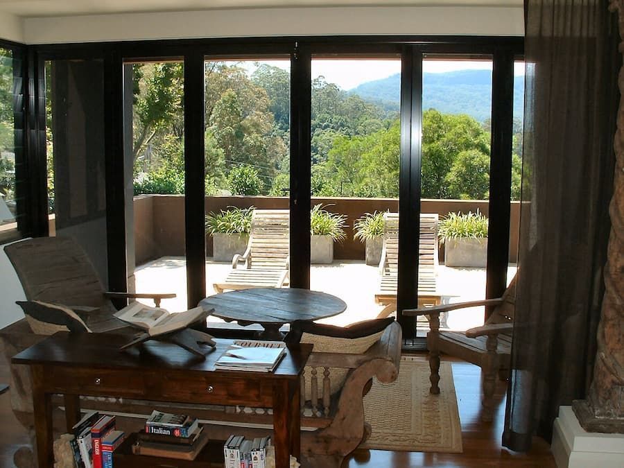 A Living Room With A Table And Chairs And A Large Window — South Coast Glass In South Nowra, NSW