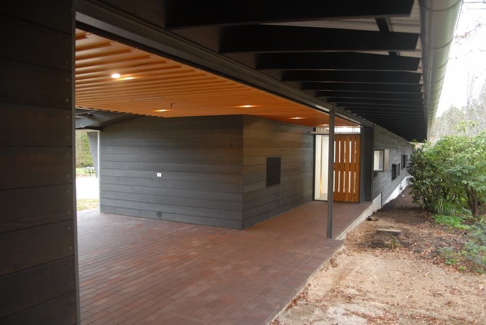 A Long Hallway With A Wooden Ceiling And A Wooden Door — South Coast Glass In South Nowra, NSW