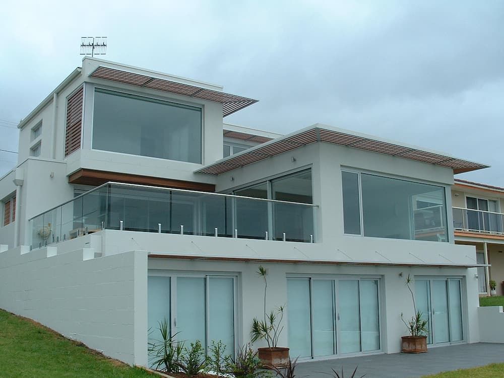 A Large White House With Lots Of Windows And A Balcony — South Coast Glass In South Nowra, NSW