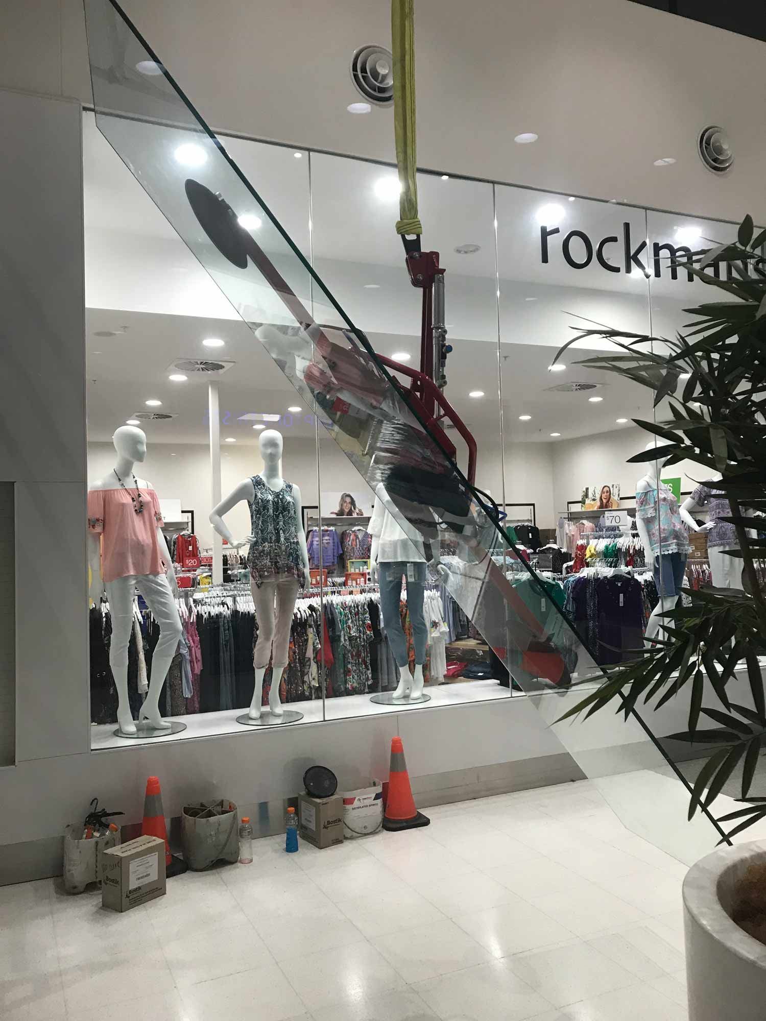 A Small Crane Used for Installing Glass Wall in Mall — South Coast Glass In South Nowra, NSW