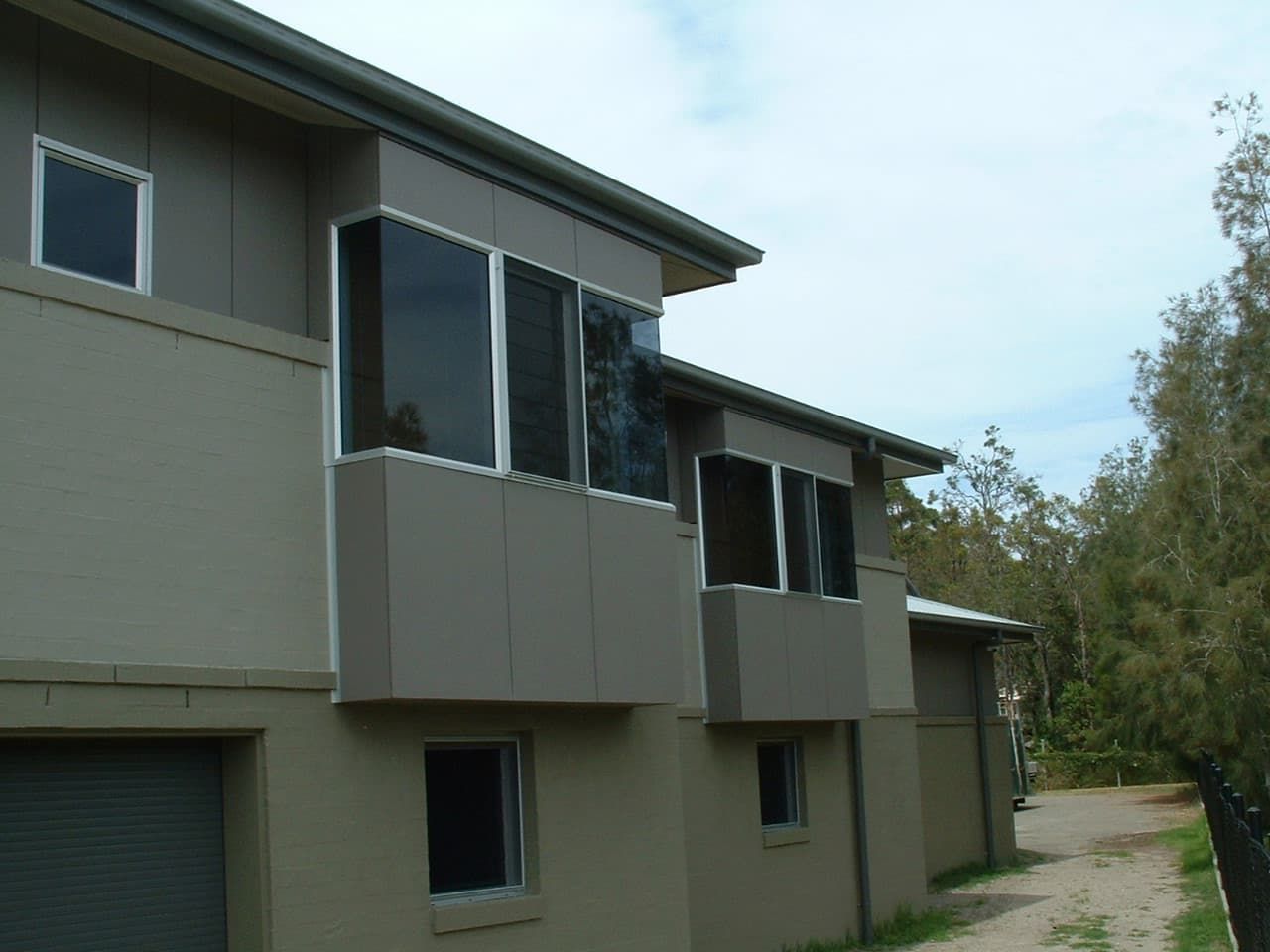 A House With A Lot Of Windows And A Garage — South Coast Glass In South Nowra, NSW