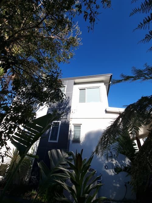 A White Building With A Blue Sky In The Background — South Coast Glass In South Nowra, NSW